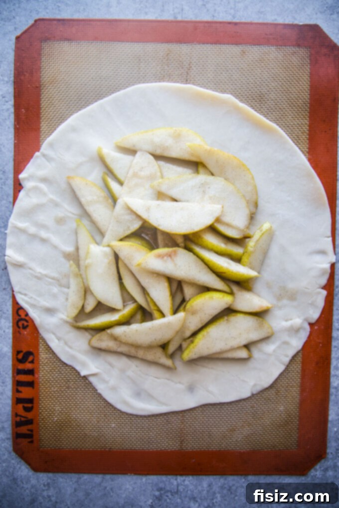 Rustic Cardamom Pear Galette 7 Unrolled pie crust on parchment paper, ready for filling