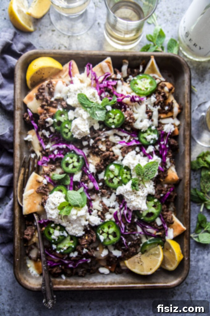 Loaded Beef Pita Nachos with Whipped Feta 2 Beef Pita Nachos with Whipped Feta - a unique twist on classic nachos, featuring crispy pita bread, seasoned ground beef, melted cheese, and creamy whipped feta. Perfect for game day or an easy weeknight meal.