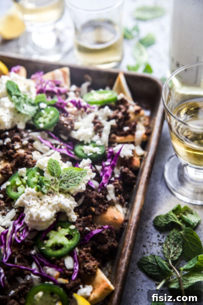 Loaded Beef Pita Nachos with Whipped Feta 3 Pita Nachos preparation: a baking sheet with golden pita triangles, ready for the delicious toppings to be added.