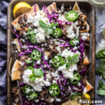 Loaded Beef Pita Nachos with Whipped Feta 10 Beef Pita Nachos with Whipped Feta - a unique twist on classic nachos, featuring crispy pita bread, seasoned ground beef, melted cheese, and creamy whipped feta. Perfect for game day or an easy weeknight meal.