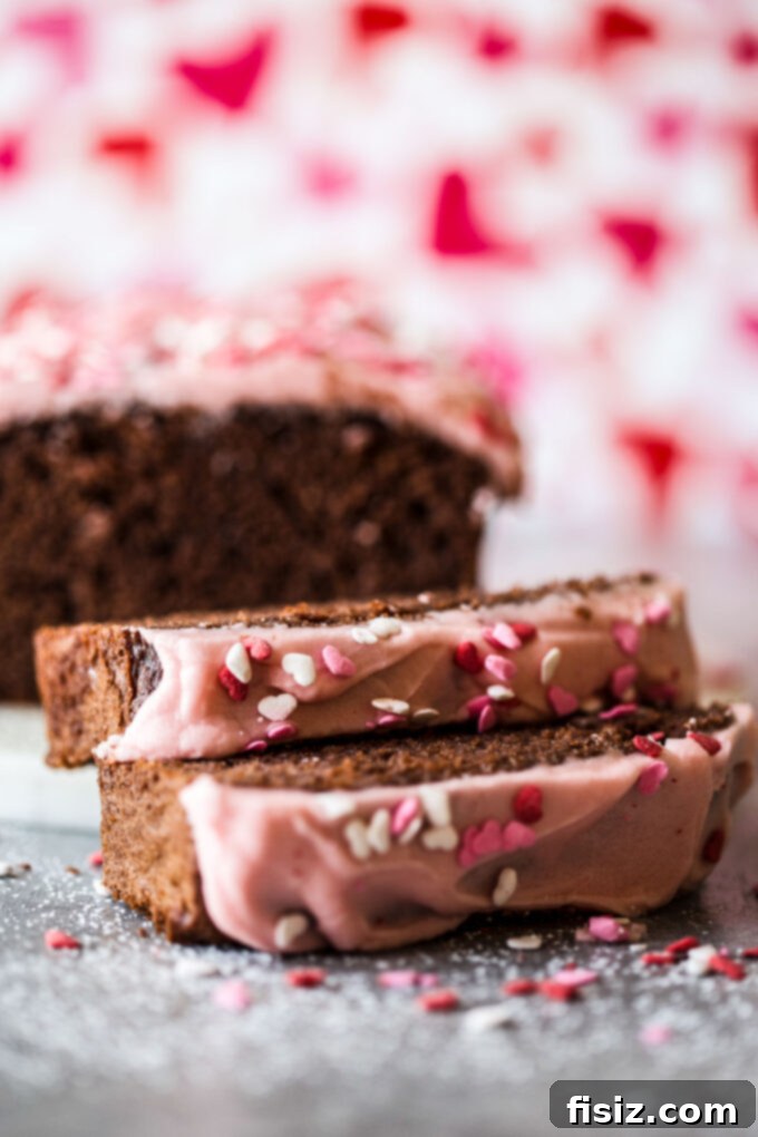 Close-up of the delicious chocolate loaf cake with cherry frosting, showcasing its beautiful texture, from www.thecuriousplate.com