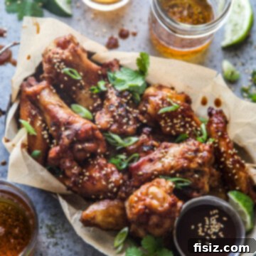 Smoky Gochujang Wings 10 Smoked Korean-Style Hot Wings on a plate with garnishes