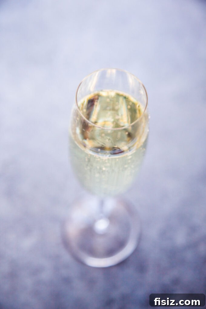 Sparkling Krispie Delights 5 Champagne Rice Krispie Treats - champagne in a glass, ready to be added to the recipe