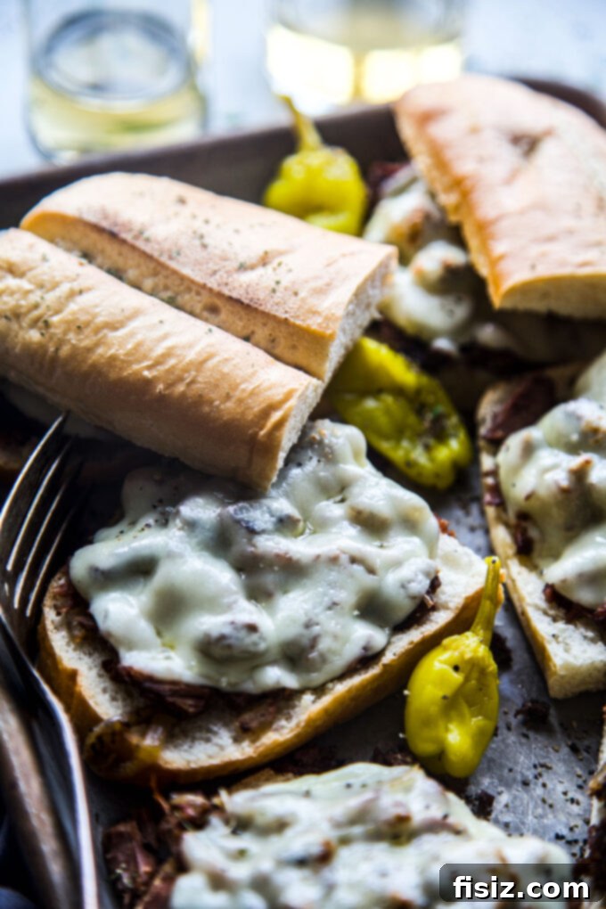 Fall-Apart Tender Slow Cooker Pot Roast Sandwiches 11 A stack of beautifully presented shredded pot roast sandwiches on a rustic plate.