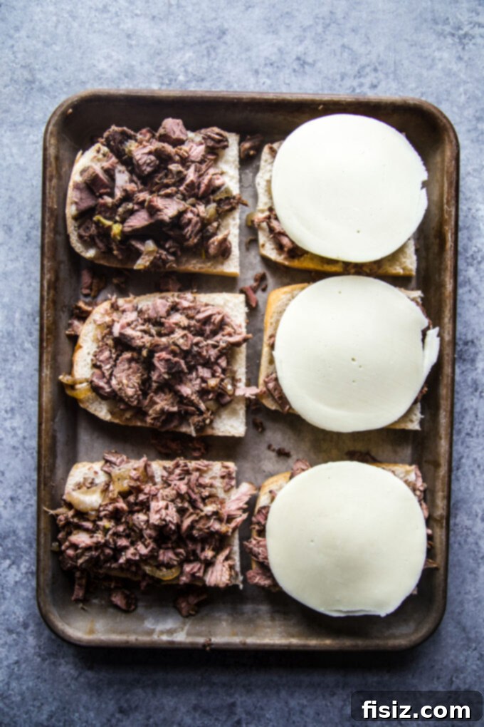 Fall-Apart Tender Slow Cooker Pot Roast Sandwiches 9 Assembled pot roast sandwiches with melted provolone cheese.