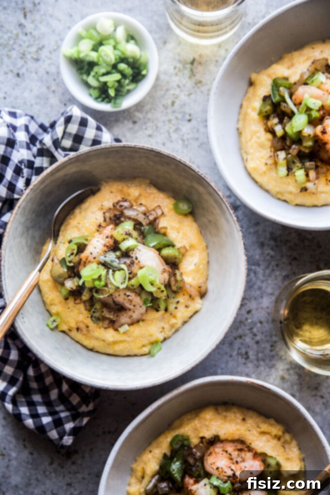 Bayou Spiced Shrimp with Creamy Polenta 2 Delicious Creole Shrimp and Polenta served in a bowl, garnished with fresh herbs.