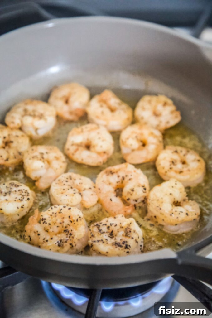 Bayou Spiced Shrimp with Creamy Polenta 4 Shrimp cooking in a hot skillet with butter and olive oil.