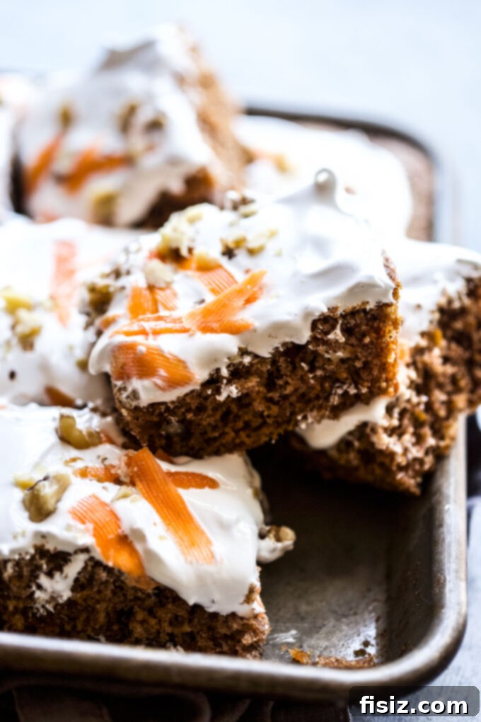 Lush Cardamom Carrot Cake with Zesty Ginger Marshmallow Frosting 2 Exquisite Cardamom-Spiced Carrot Cake with Ginger Marshmallow Frosting, ready to serve