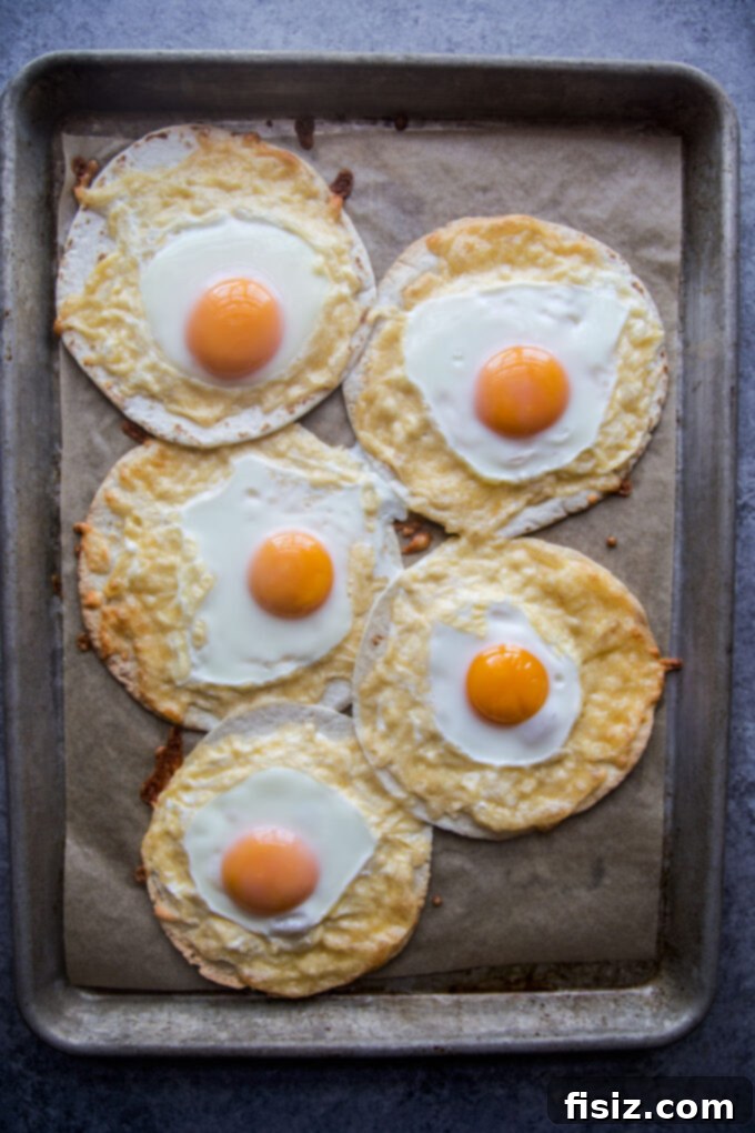 One-Pan Breakfast Tacos with Zesty Scallion Salsa 5 Freshly baked Sheet Pan Breakfast Tacos on a baking sheet, golden and delicious.