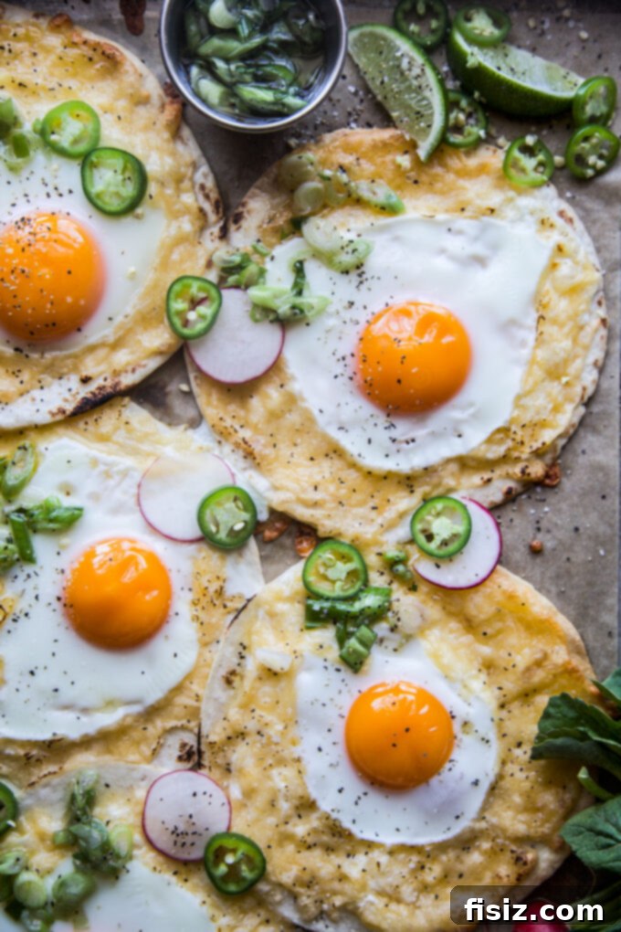 One-Pan Breakfast Tacos with Zesty Scallion Salsa 9 Close-up of a stack of Sheet Pan Breakfast Tacos on a white plate with fresh salsa.