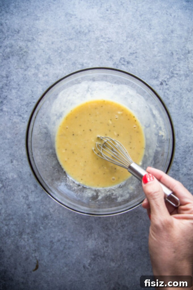 Fiesta Caesar Salad 5 Creamy Tex-Mex Caesar dressing in a bowl, ready to be tossed with salad