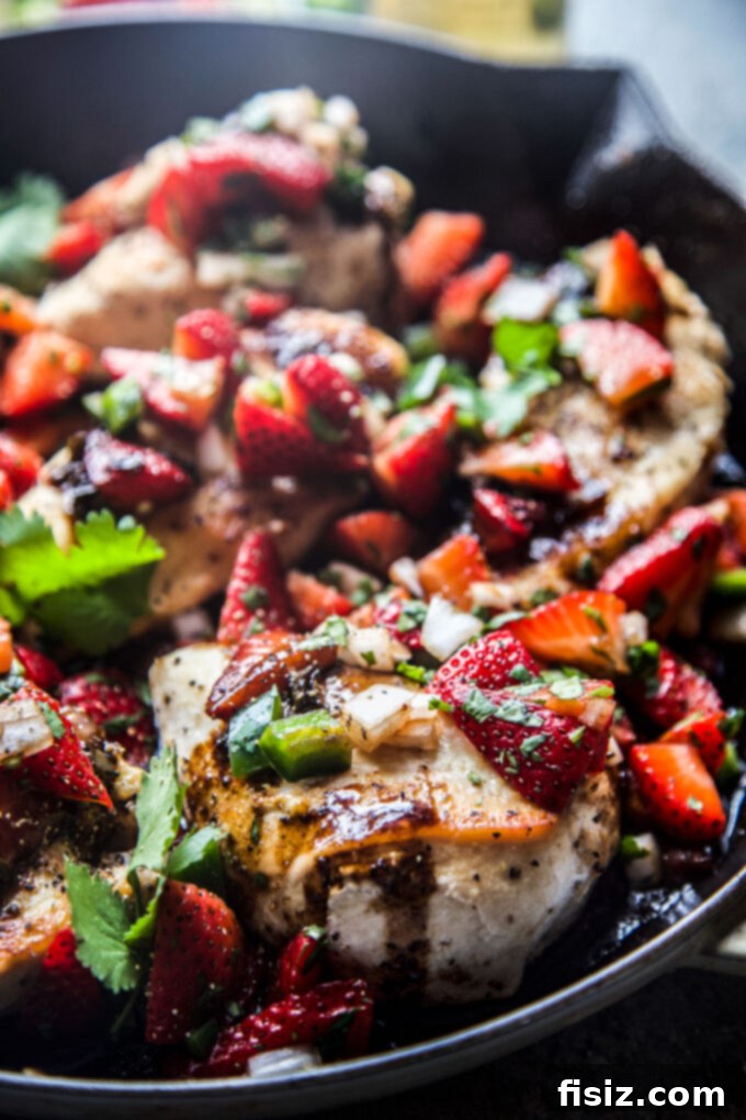 Sweet Heat Strawberry-Jalapeño Chicken 3 A top-down view of Strawberry Jalapeño Skillet Chicken, garnished with fresh herbs.