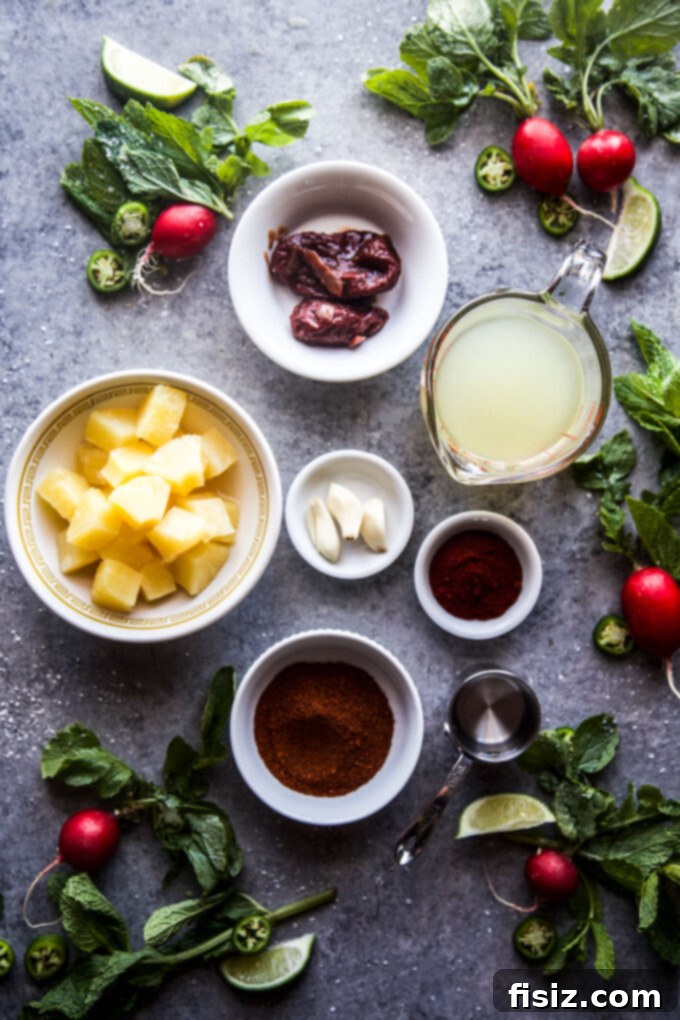 Melt-in-Your-Mouth Slow Cooker Al Pastor Lamb Tacos 6 Individual ingredients for Al Pastor sauce, neatly arranged on a cutting board