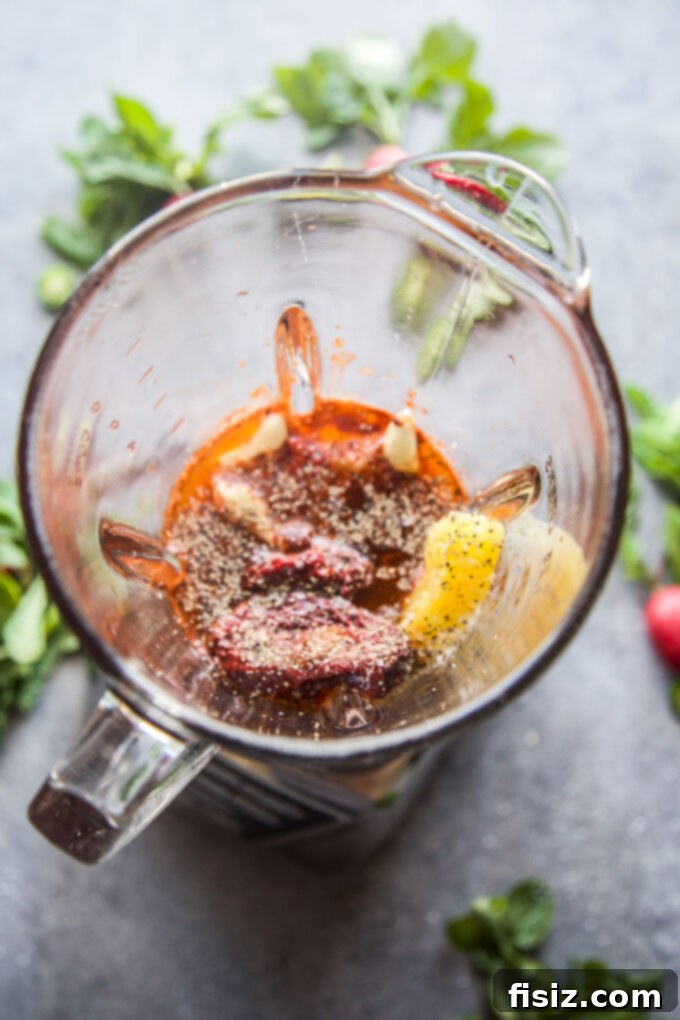 Melt-in-Your-Mouth Slow Cooker Al Pastor Lamb Tacos 7 Al Pastor ingredients being blended in a food processor to create a smooth marinade