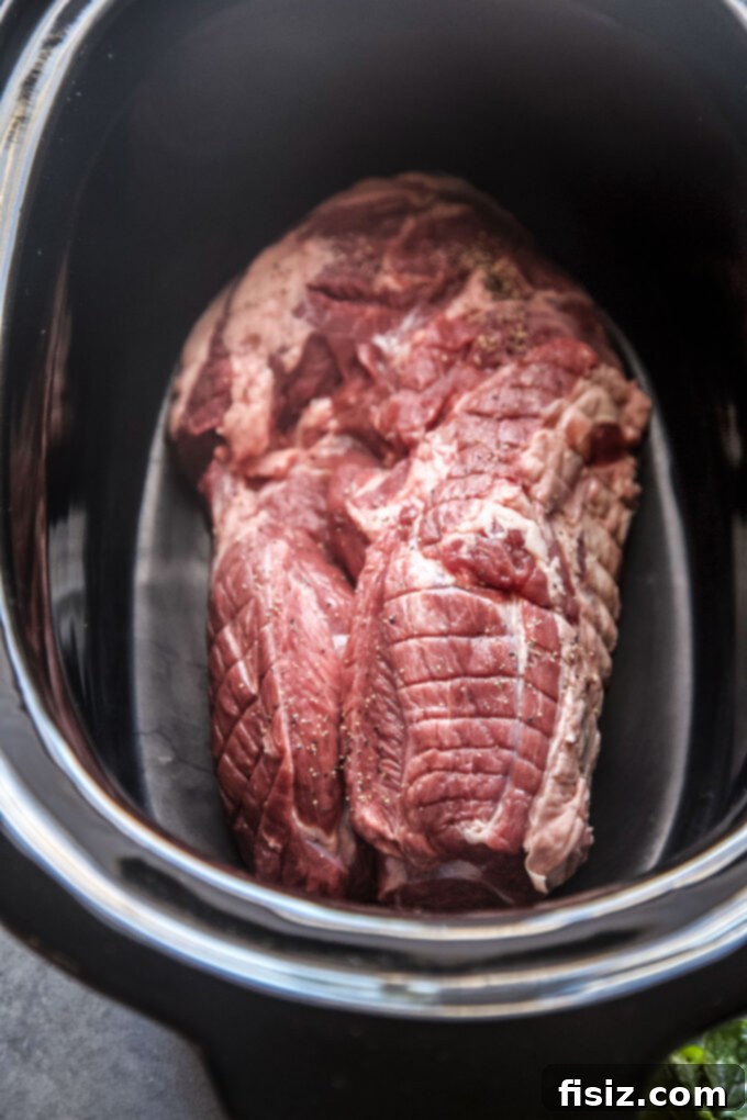 Melt-in-Your-Mouth Slow Cooker Al Pastor Lamb Tacos 9 Boneless lamb shoulder placed inside a slow cooker before adding the sauce