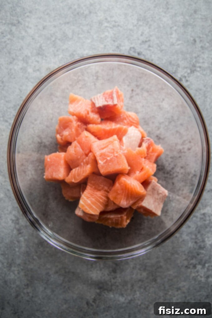 Crispy Air Fryer Greek Salmon Bites 4 Fresh cubed salmon pieces ready for seasoning