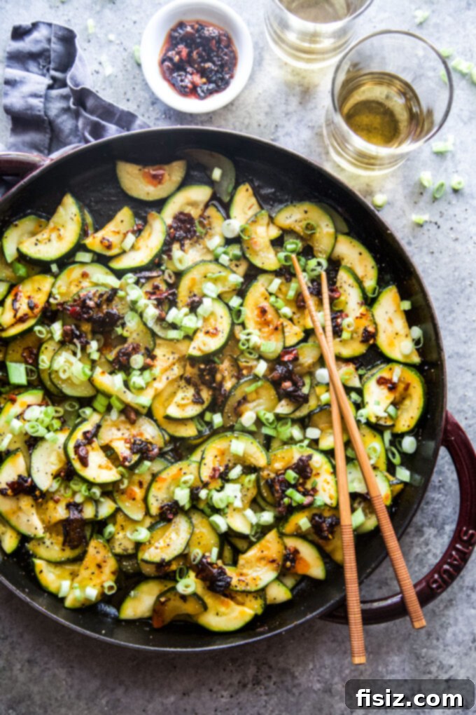 Chili Crisp Zucchini Sizzle 2 Sizzling spiced zucchini with vibrant chili crisp and green onion garnish, a quick and delicious side dish.
