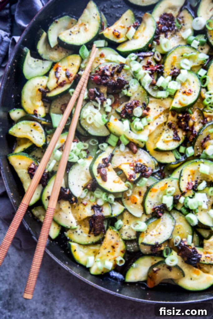 Chili Crisp Zucchini Sizzle 3 Freshly cooked spiced zucchini tossed with chili crisp, ready to be plated and enjoyed.