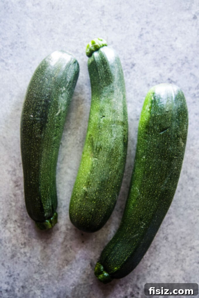 Chili Crisp Zucchini Sizzle 4 Three fresh whole zucchinis, ready for slicing and cooking.