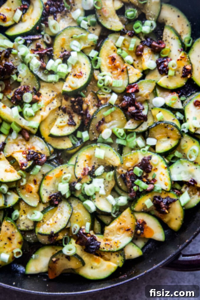 Chili Crisp Zucchini Sizzle 8 A vibrant plate of spiced zucchini with chili crisp, garnished with green onions, ready to eat.