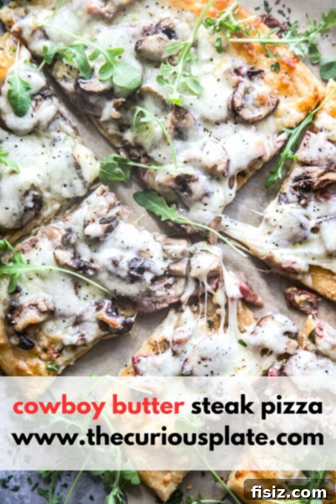 Cowboy Butter Steakhouse Pizza 13 a close-up shot of a single slice of cowboy butter steak pizza