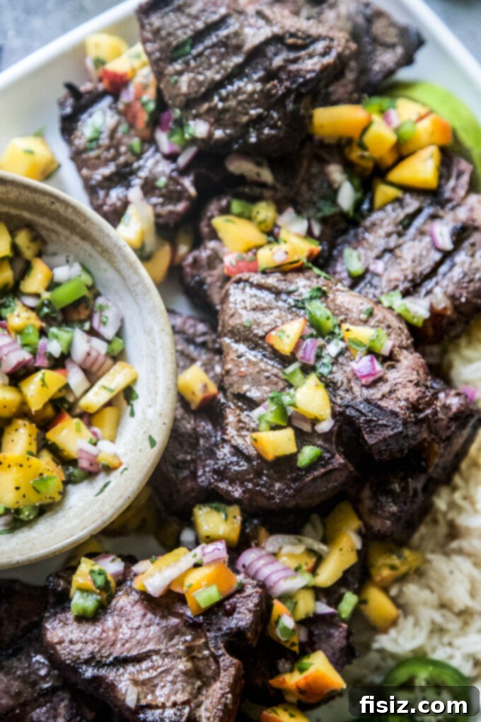 Spicy Jerk Lamb Loin Chops, Sweet Peach Salsa 3 Grilled Jerk American Lamb Loin Chops with vibrant Peach Salsa served outdoors