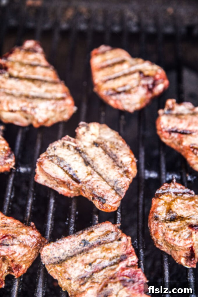 Spicy Jerk Lamb Loin Chops, Sweet Peach Salsa 9 Grilled jerk American lamb loin chops on a hot grill
