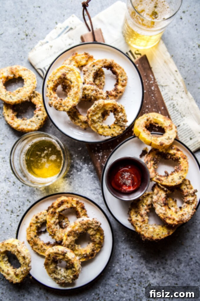 Crispy Air Fryer Squash Rings 2 Crispy golden Air Fryer Squash Rings stacked on a plate