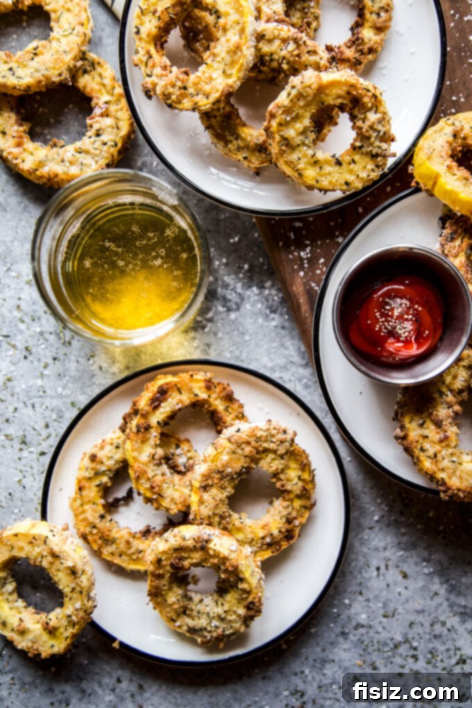 Crispy Air Fryer Squash Rings 3 Close-up of golden brown Air Fryer Squash Rings on a white plate