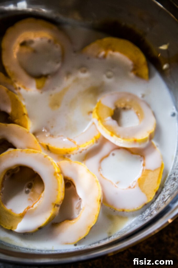 Crispy Air Fryer Squash Rings 5 Delicata squash slices marinating in buttermilk mixture