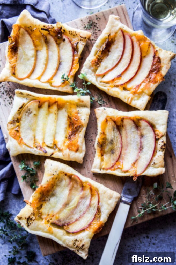 Apple & Cheddar Upside Down Tart with Caramelized Rum Onions: A gourmet appetizer with crisp apples, sharp cheddar, and rich rum-infused onions