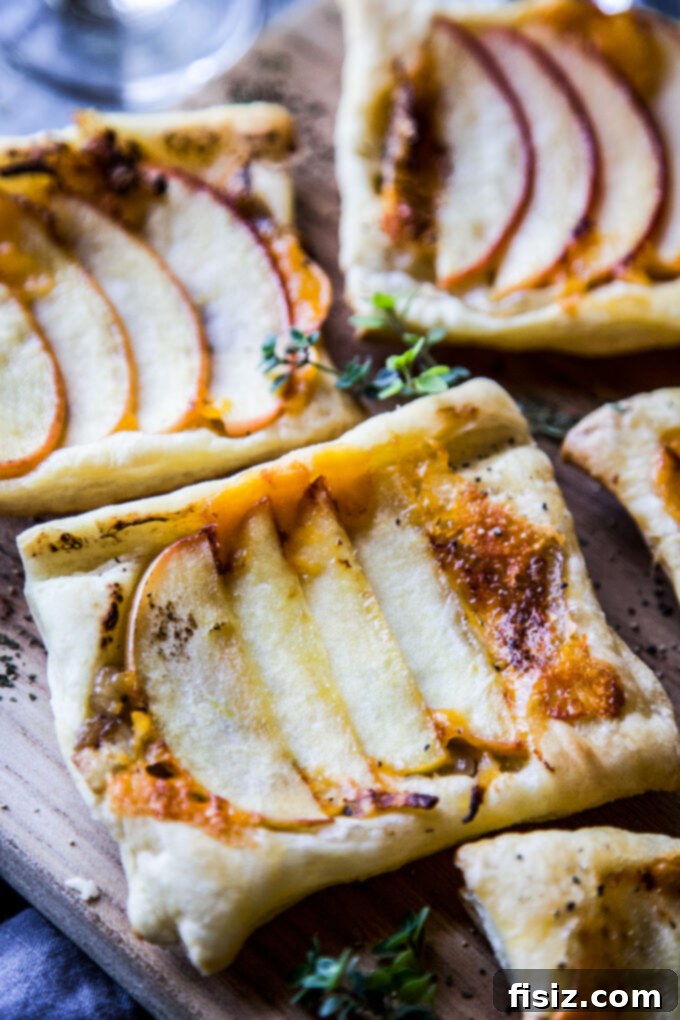Close-up of Apple & Cheddar Upside Down Tart with Caramelized Rum Onions, showcasing golden crust and rich filling