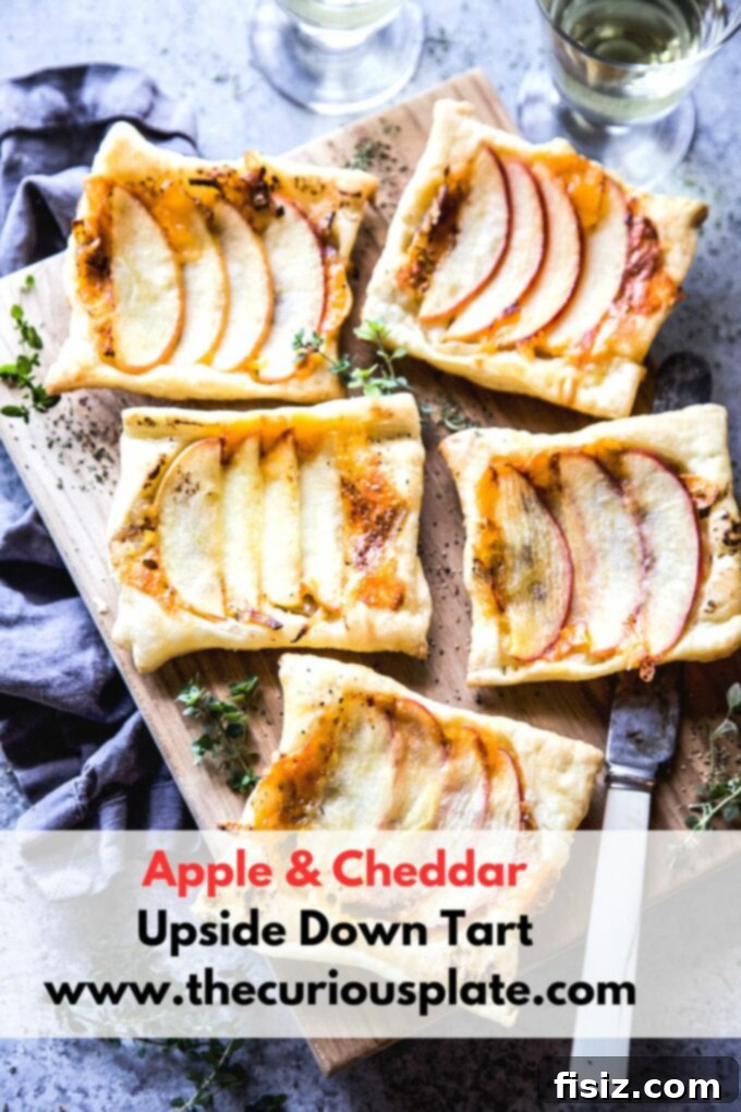Finished Apple & Cheddar Upside Down Tart, golden and inviting on a wooden board