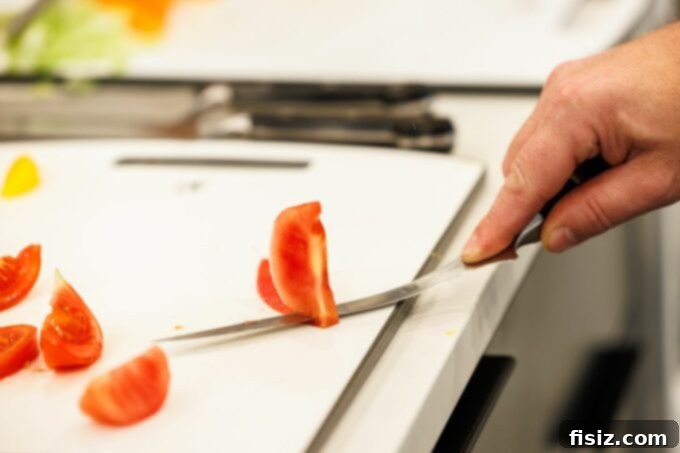 Zwilling fish knife effortlessly cutting a ripe tomato, demonstrating precision