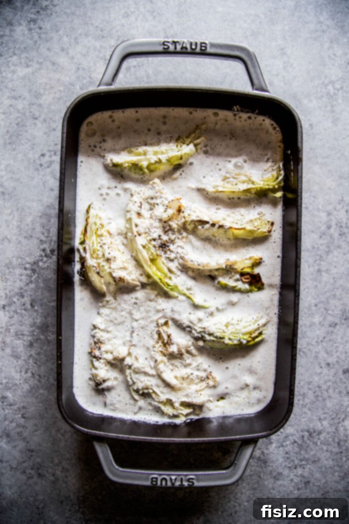Golden Baked Cabbage Gratin 7 roasted cabbage in casserole dish covered by white sauce
