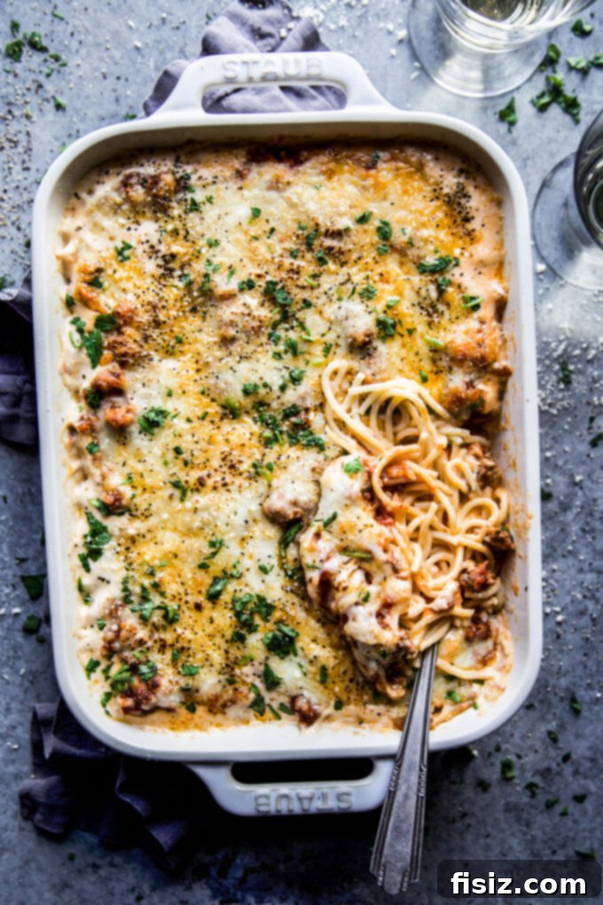 Creamy Baked Alfredo Spaghetti 2 A bubbling, golden-brown Spaghetti Alfredo Casserole fresh from the oven, showcasing its cheesy top and hearty layers.