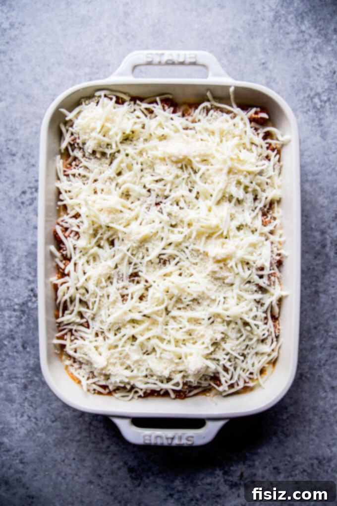 Creamy Baked Alfredo Spaghetti 6 An unbaked Spaghetti Alfredo Casserole, fully assembled with layers of pasta, sauce, and cheese, awaiting its golden transformation in the oven.
