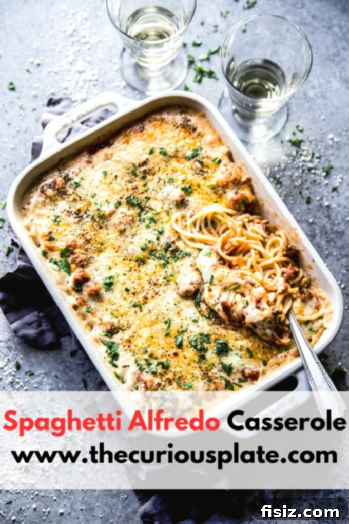 Creamy Baked Alfredo Spaghetti 10 A large serving of Spaghetti Alfredo Casserole, garnished and ready to be served, highlighting its comforting appeal.