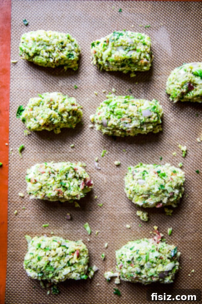 Gourmet Brussels Sprout Bacon Blue Cheese Tots 6 Uncooked Bacon Blue Cheese Brussels Sprout Tater Tots neatly arranged on a baking sheet