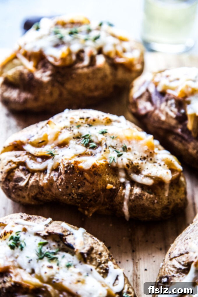 Ultimate French Onion Baked Potatoes 8 A final, mouth-watering close-up of a French onion baked potato, with steam rising.