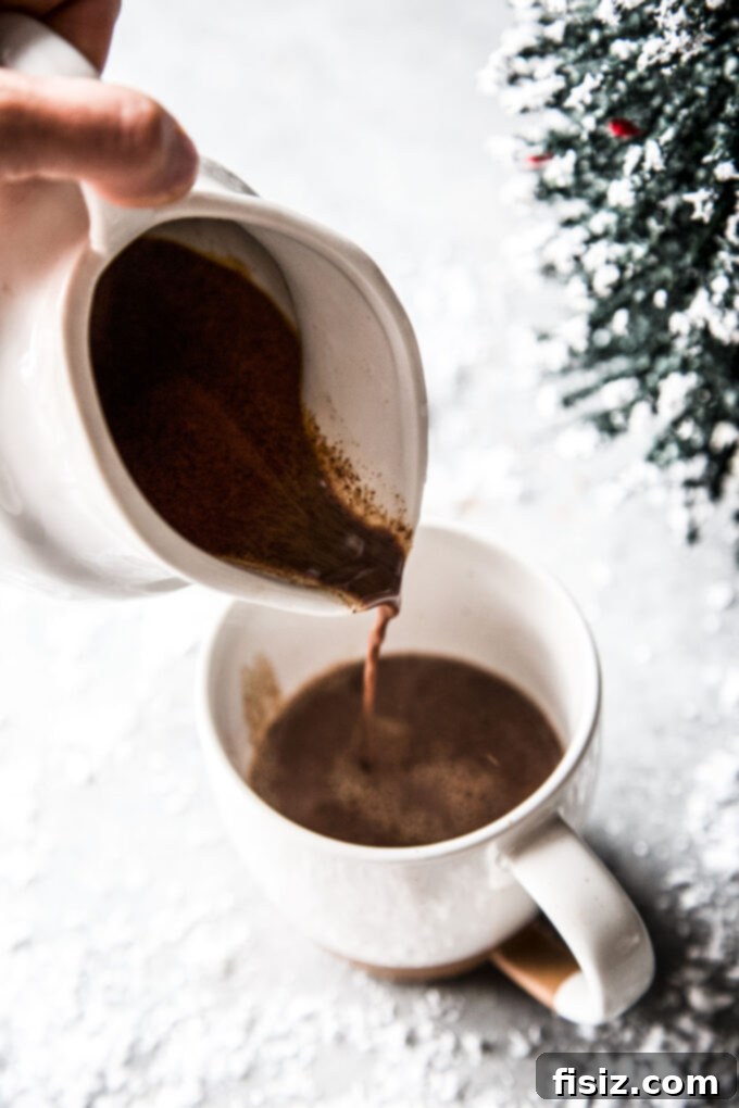 Decadent Tahini Hot Chocolate 6 easy tahini hot chocolate being poured into a mug