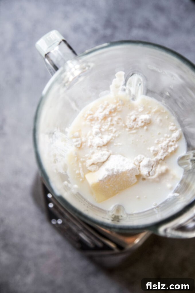 Effortless Creamy Cottage Cheese Alfredo 5 Cottage cheese and milk being blended for a smooth, creamy sauce