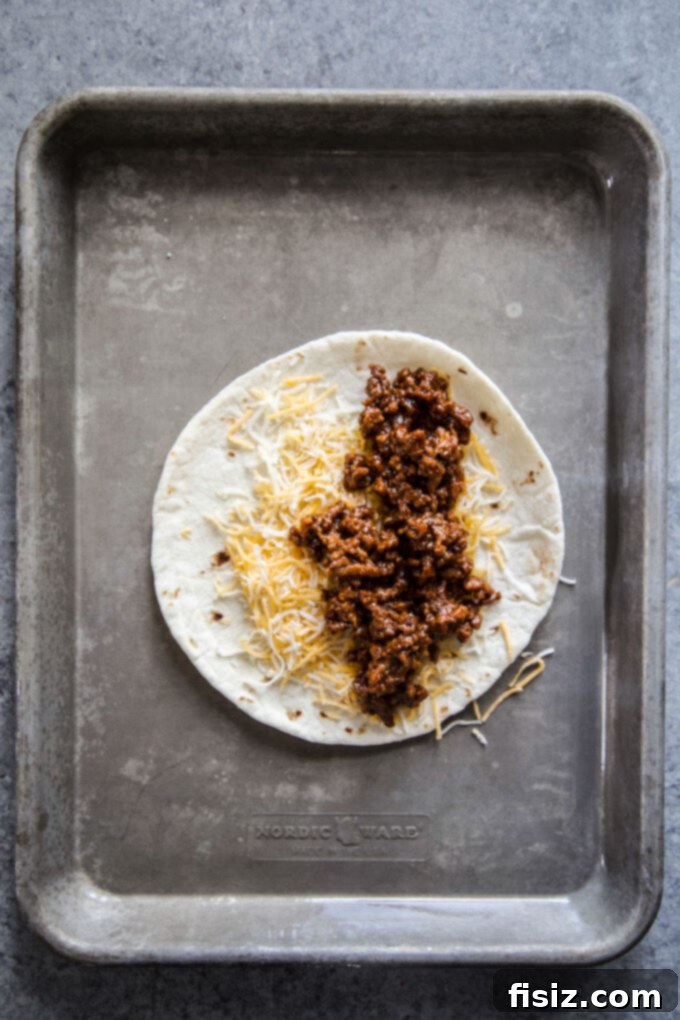 Smoky Brisket Tacos with a Crunchy Shell 5 crispy bbq beef tacos on a baking sheet open faced