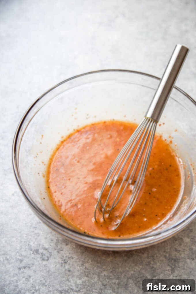 Honey Harissa Glazed Chicken Tenders 5 Smooth and rich harissa honey glaze in a saucepan, ready to be brushed on chicken.