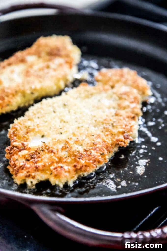 Spicy Buffalo Chicken Parmesan 7 chicken parmesan being cooked in a skillet