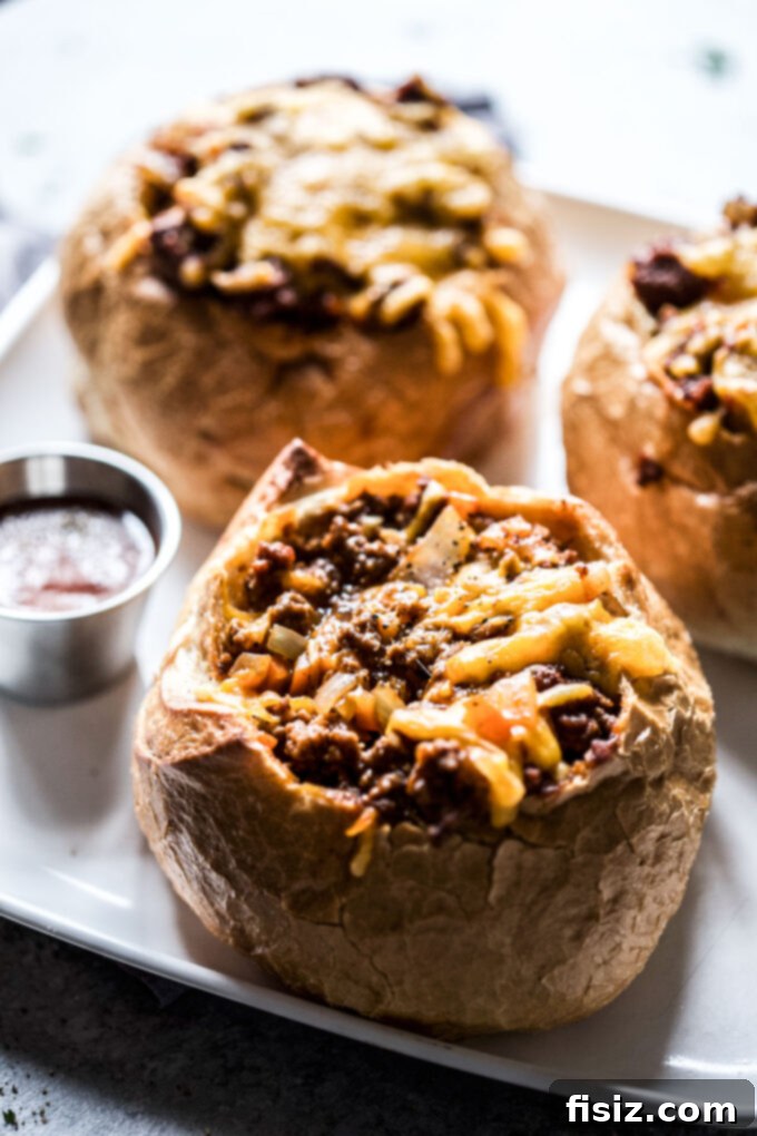 Loaded BBQ Sloppy Joe Bread Bowls 8 Final presentation of a gourmet BBQ Sloppy Joe Bread Bowl, beautifully garnished with fresh herbs