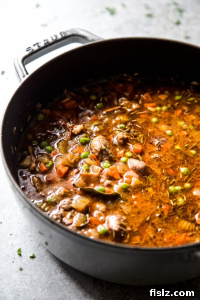 Individual American Lamb Shoulder Shepherd's Pie 6 Vegetables like onions, carrots, and celery sautéing in a Dutch oven, forming the aromatic base for Shepherd's Pie.