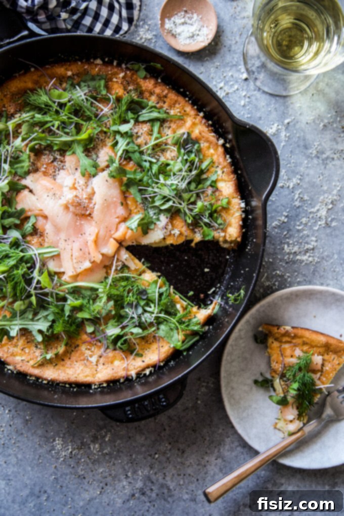 Herbed Protein Skillet Cakes 7 A slice of High Protein Herbed Skillet Pancake with smoked salmon and fresh herbs, ready to be served. www.thecuriousplate.com