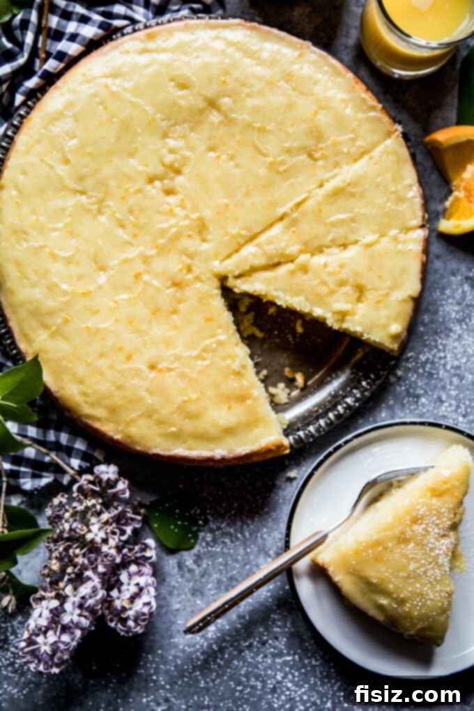 Velvety Citrus Ricotta Cake with a Bright Orange Drizzle 3 Close-up of a slice of moist Citrus Ricotta Cake with vibrant orange glaze