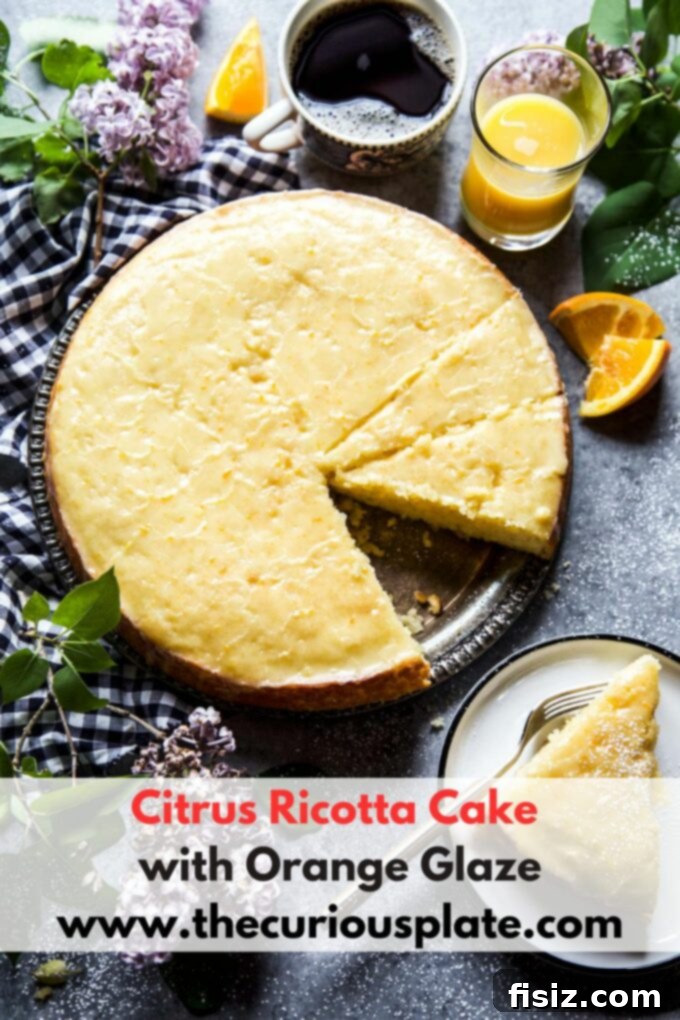 Velvety Citrus Ricotta Cake with a Bright Orange Drizzle 10 Beautifully glazed Citrus Ricotta Cake on a serving plate, garnished with orange zest